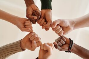 A diverse group of people supporting one another gently